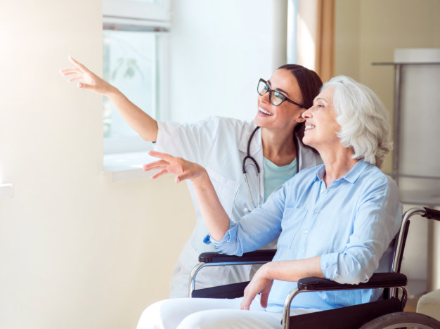 portrait of a smiling old woman together with her nurse